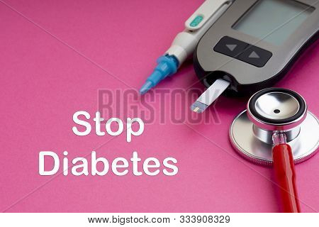 Syringe, Glucometer Or Glucose Meter And Stethoscope With Words Stop Diabetes On Pink Background. Di