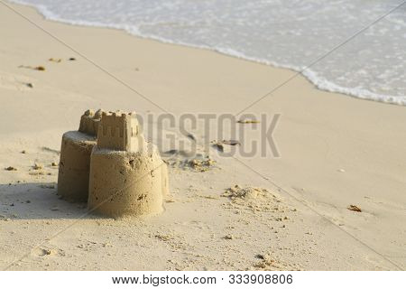 Sand Castle On The Beach. Children Build Sand Castles On The Beach.