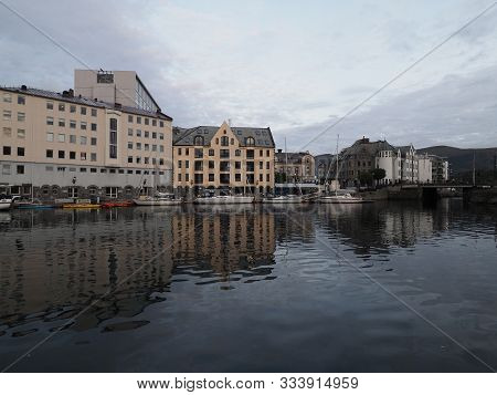 Yachts And Secessionist Center Of European Town Of Alesund Reflected In Water At Romsdal Region In N