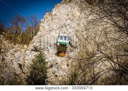 Cableway With Blue Sky And Rocks Background. Cable Cabin In Moravia. Macocha Cable Tramway.