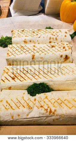 Juicy Shawarma Close-up. Close Up View Of Eat Fresh Street Fast Food. Dish With Beef Salad Filled Ro