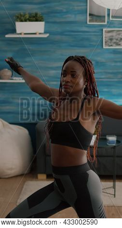 Slim Fit Athetic Black Woman Wearing Sportswear Training Leg Stand Posture Sitting On Yoga Map In Li