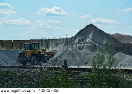 In The Background, A Working Tractor With A Bucket. Voronezh Region. Russia. July 2021