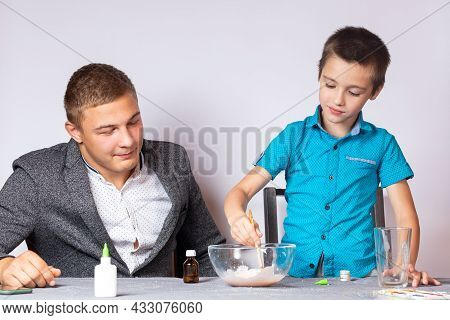 Chemistry Education And Training Concept. Close-up Of A Boy And His Dad Doing A Home Chemical Experi