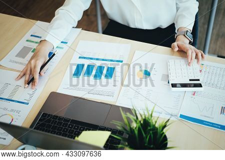 Focus Woman Holding A Pencil Auditors Use Budget Document Calculators To Find Annual Budget Disburse