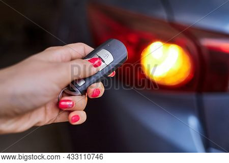 The Car Owner Holds In His Hand A Remote Control Device For Keyless Entry. Close-up, Selective Focus