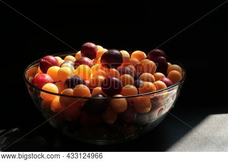 Ripe Cherry Plum Of Different Varieties In A Glass Bowl On The Table.