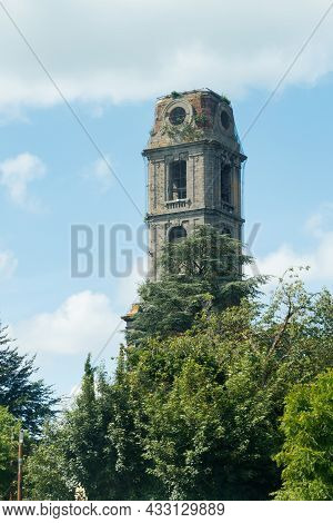 Old Tower Of Cambron Abbey At Pairi Daiza, Belgium Against Blue Sky