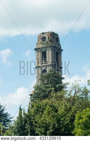 Old Tower Of Cambron Abbey At Pairi Daiza, Belgium Against Blue Sky