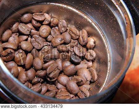 Natural Coffee Beans In Placers In Coffee Grinder Before Grinding
