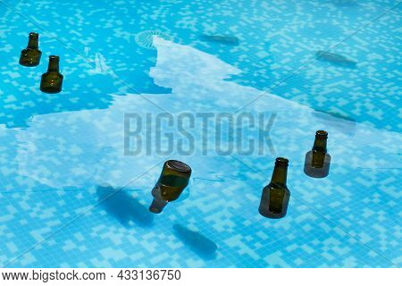 Empty Beer Bottles Inside A Swimmming Pool
