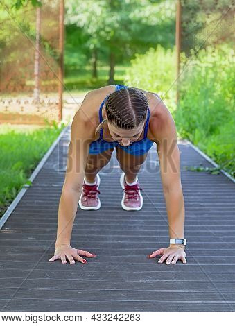 Sports Girl Makes A Plank In The Park