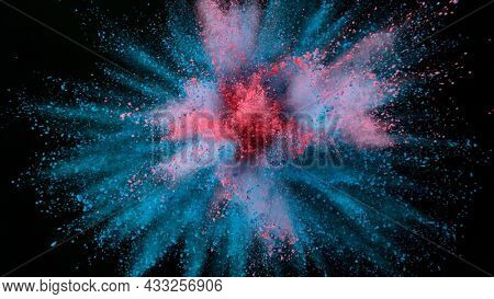 Freeze motion shot of color powder explosion isolated on black background, close-up.