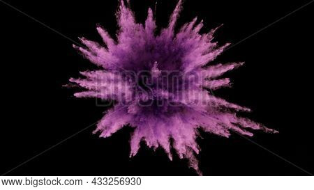 Freeze motion shot of color powder explosion isolated on black background, close-up.