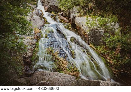 Lomiczka waterfall in polish part of Karkonosze Moutains, near Sniezka. Mountain river in Karkonosze National Park, Poland.