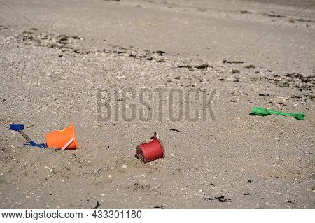 Closeup View Of Colorful Children Plastic Toys Left Or Forgotten At Sandymount Beach After Messy Sea