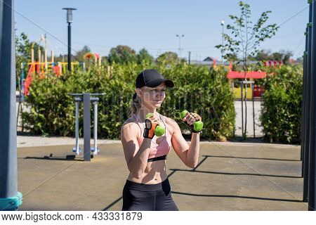 Sportive Woman Working Out On The Sports Ground In Sunny Summer Day