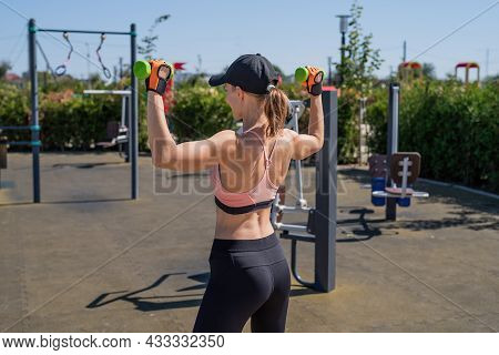 Sportive Woman Working Out On The Sports Ground In Sunny Summer Day