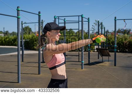 Sportive Woman Working Out On The Sports Ground In Sunny Summer Day