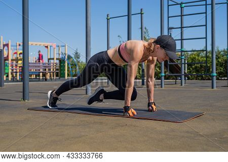 Sportive Woman Working Out On The Sports Ground In Sunny Summer Day