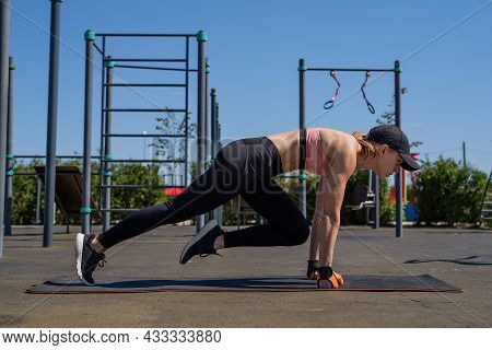Sportive Woman Working Out On The Sports Ground In Sunny Summer Day