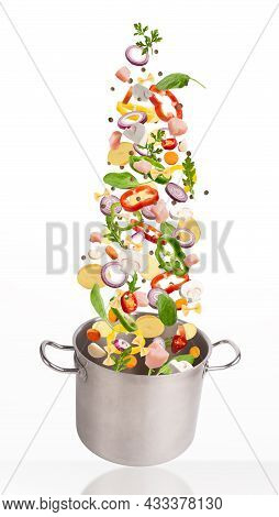 Fresh Vegetables Flying Into Sausepan, Isolated On White Background