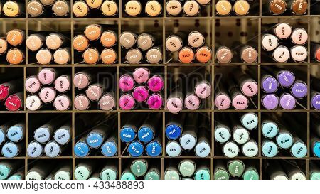 Sketching Markers Are Organized Into Cells On The Shelf Of An Artist Store. Alcohol Markers Close-up