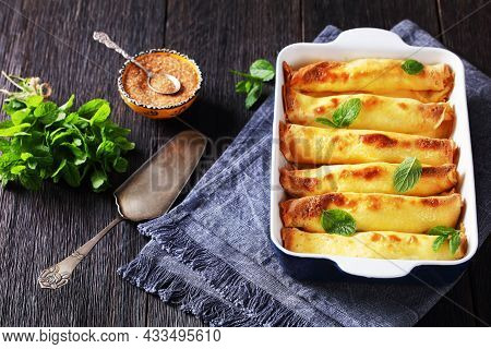 Blintz, Rolled Filled With Sweetened Cottage Cheese Pancakes Or Crepes In A Baking Dish On A Wooden 