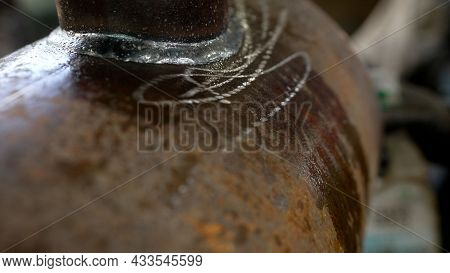Checking The Metal Valve For Waterproofing. Pipe Waterproofing At The Factory. Checking The Pipe For