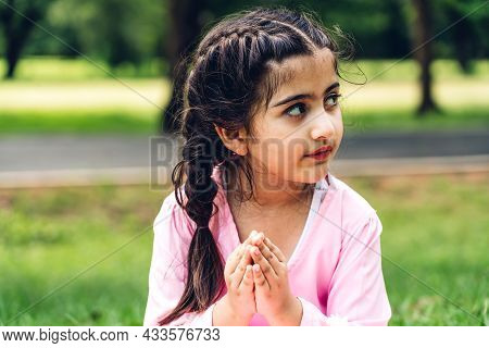 Portrait Of Happy Little Muslim Girls Child With Hijab Dress Smiling And Looking At Camera In The Pa