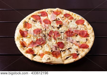 A Whole Rustic Pizza With Mozzarella, Brisket, Mushrooms And Salami