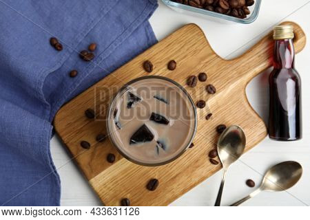 Glass Of Milk With Grass Jelly And Coffee Beans On White Wooden Table, Flat Lay