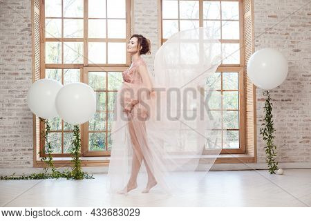 Full Length Side View Portrait Of Sensual Cheerful Beautiful Pregnant Young Woman In Pink Dress Flyi