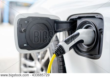 Old Electric Supply Plug For Electric Car With Power Supply In A Car Charging Station