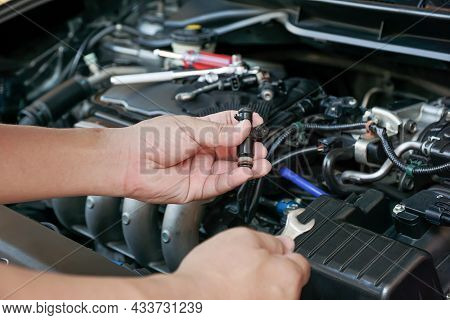 Technician Removing The Petrol Engine Injector In Engine Room Maintenance Concept