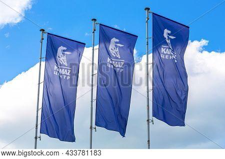 Samara, Russia - July 2, 2021: Kamaz Dealership Flags Over Blue Sky. Kamaz Is A Russian Automaker Co