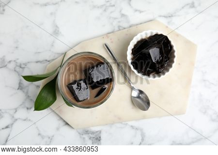 Glass Of Milk With Grass Jelly On White Marble Table, Top View