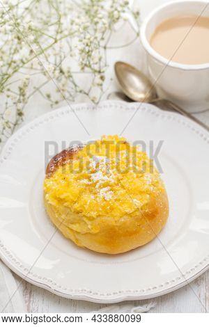 Traditional Portuguese Bread Pao De Deus On White Dish On Wooden Background