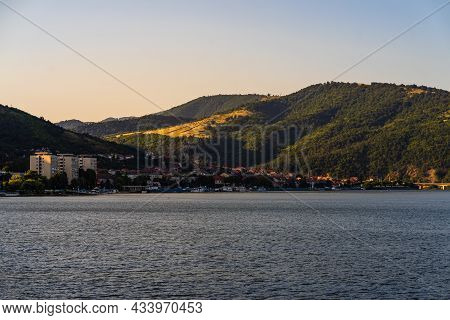View Of Danube River And Orsova City Vegetation And Buildings, Waterfront View. Orsova, Romania, 202