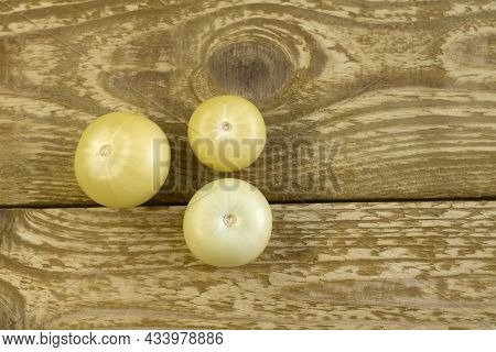 Bright Unripe Yellow Tonatoes Close Up Flat Lay Photo On Brown Textured Wooden Background Top View