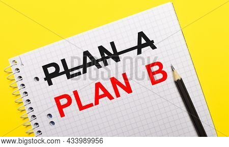 White Notebook With Inscription Plann B Written In Black Pencil On A Bright Yellow Background.