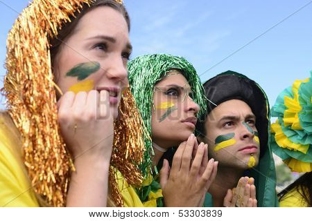 Group of brazilian soccer fans concerned with the performance of the Brazilian national team