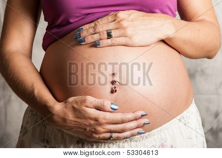 Hands upon baby tummy