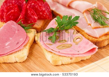 Sandwiches With Salami, Bacon And Mortadella