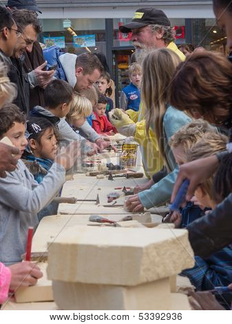 Kids Learning To Carve At Sculpture Festival