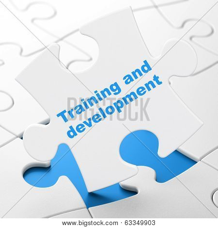 Education concept: Training and Development on puzzle background
