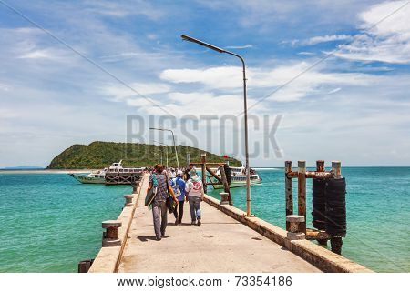 SAMUI, THAILAND - 3 JUNE, 2010: Tourists walk along the pier to the boat to Koh Phangan. On Phangan each month are beach parties called 