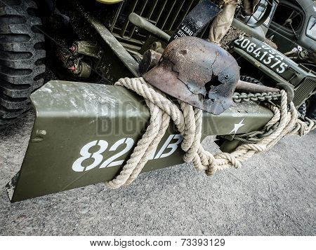 Old damaged war helmet on car bumper