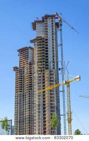 Inustrial construction cranes working on building
