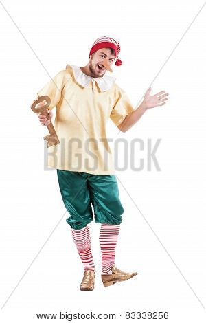 Young smiling man posing in Pinocchio costume or russian buratino